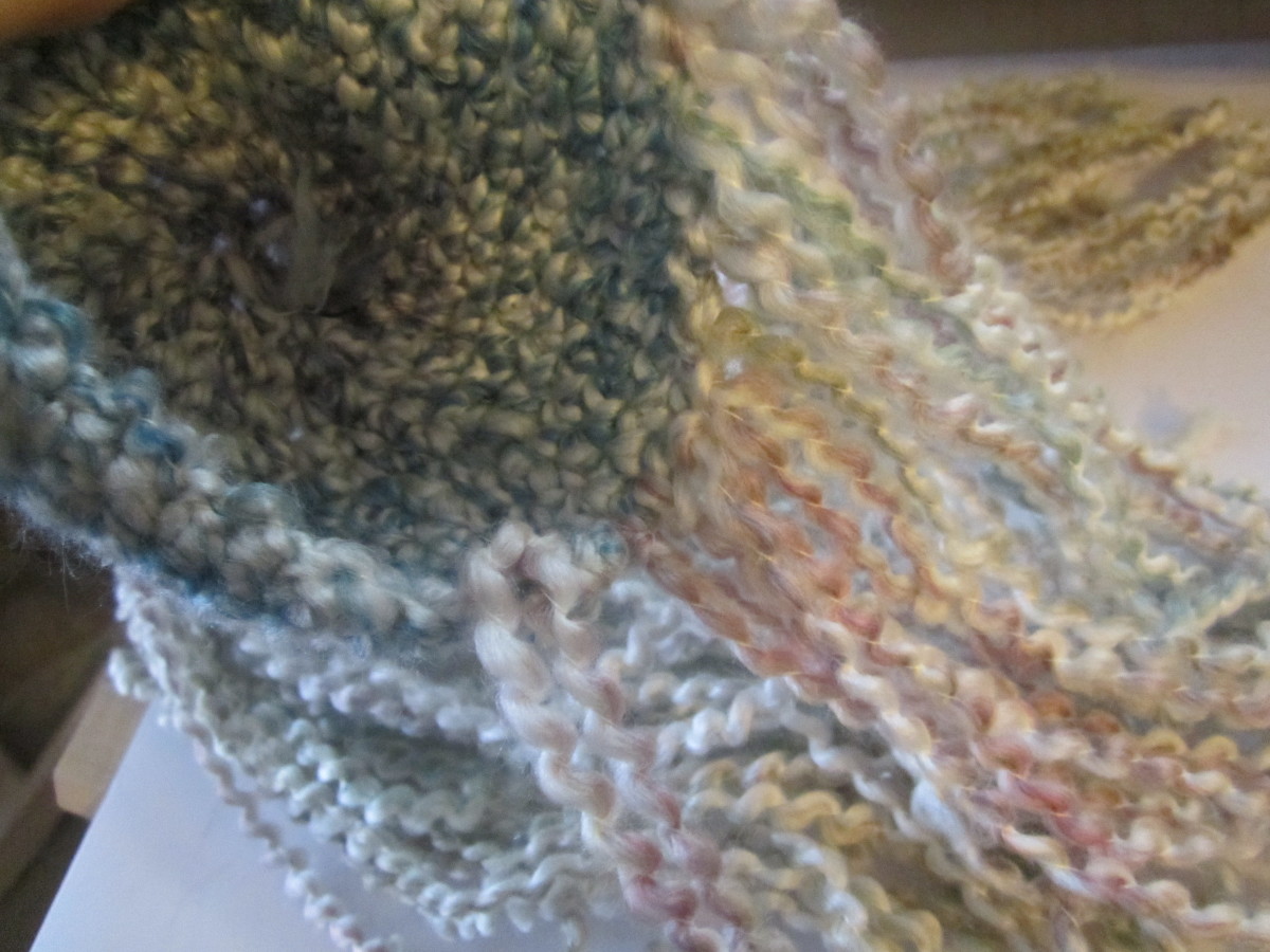 Loop your "U" in you hook, and pull the tails through stitches to knot them. Work around the edge of the cap. Loop your "U" in you hook, and pull the tails through stitches to knot them. Work around the edge of the cap.