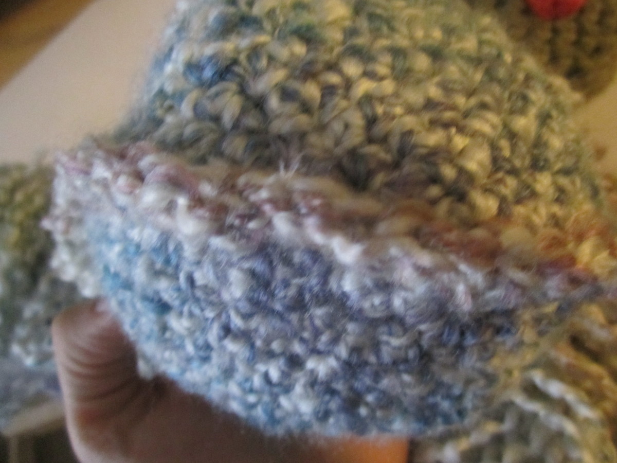 Now you will latch hook strands of hair on either side on the single crochet row part. Now you will latch hook strands of hair on either side on the single crochet row part.