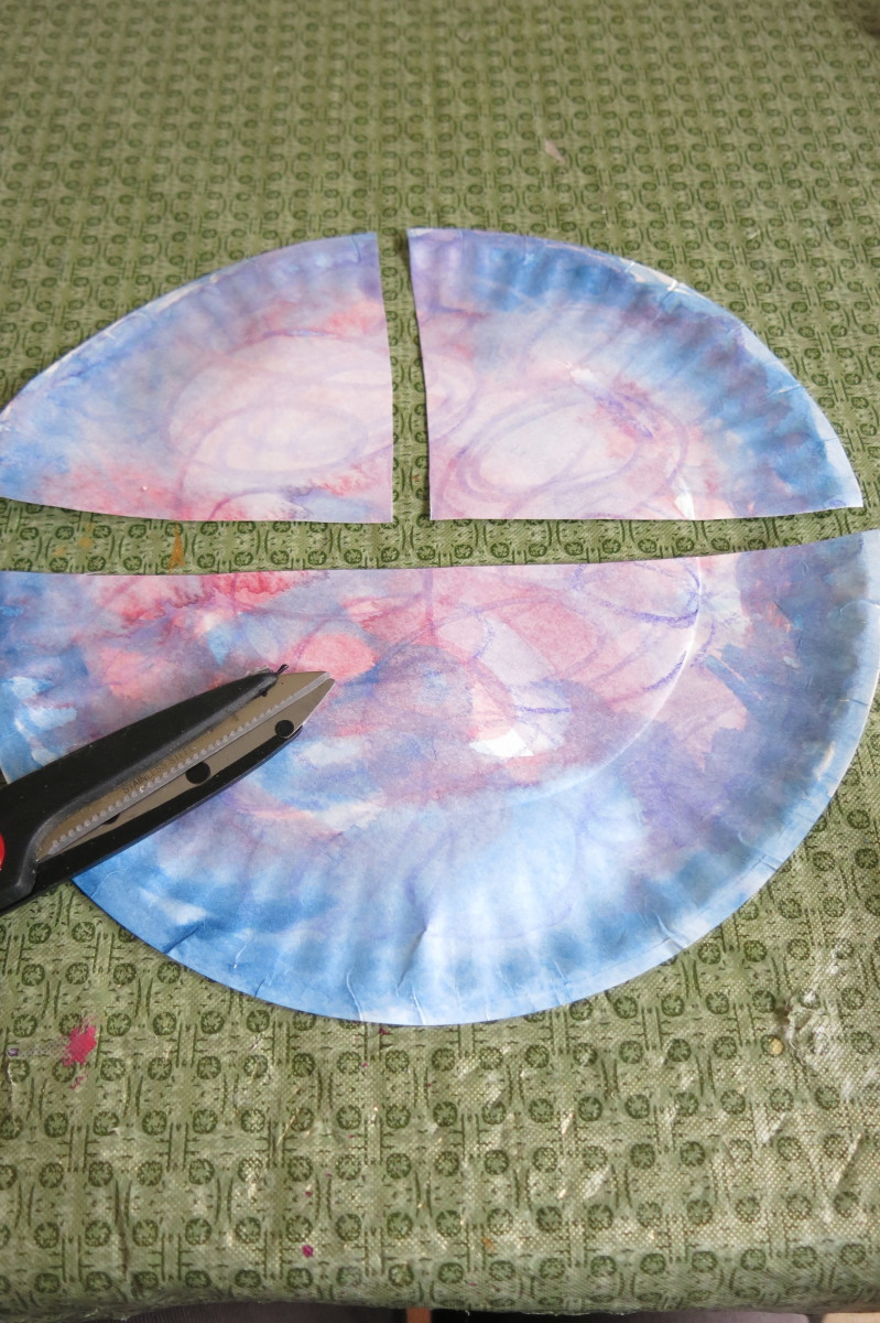Cut your paper plate into three pieces as shown to start to make the body of your angel.