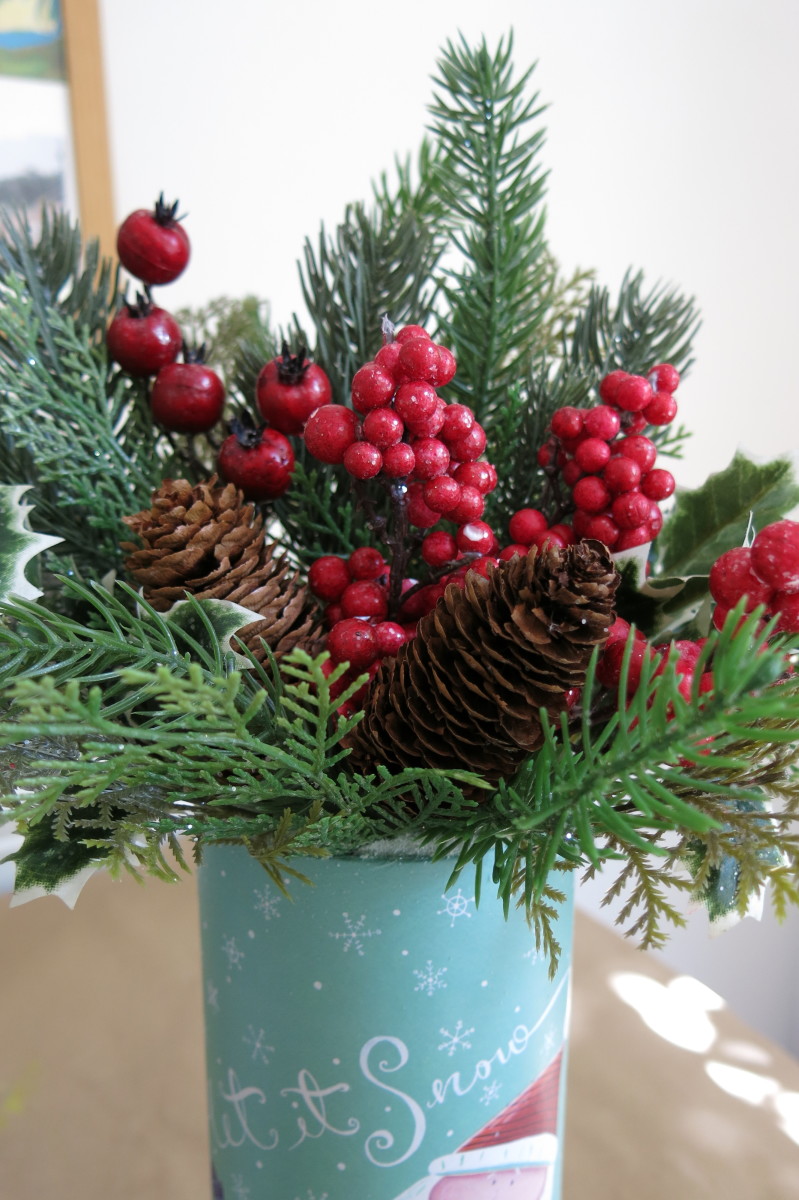 Once I had an arrangement that I liked, I hot glued a couple of pine cones in place to add some different texture to my design.