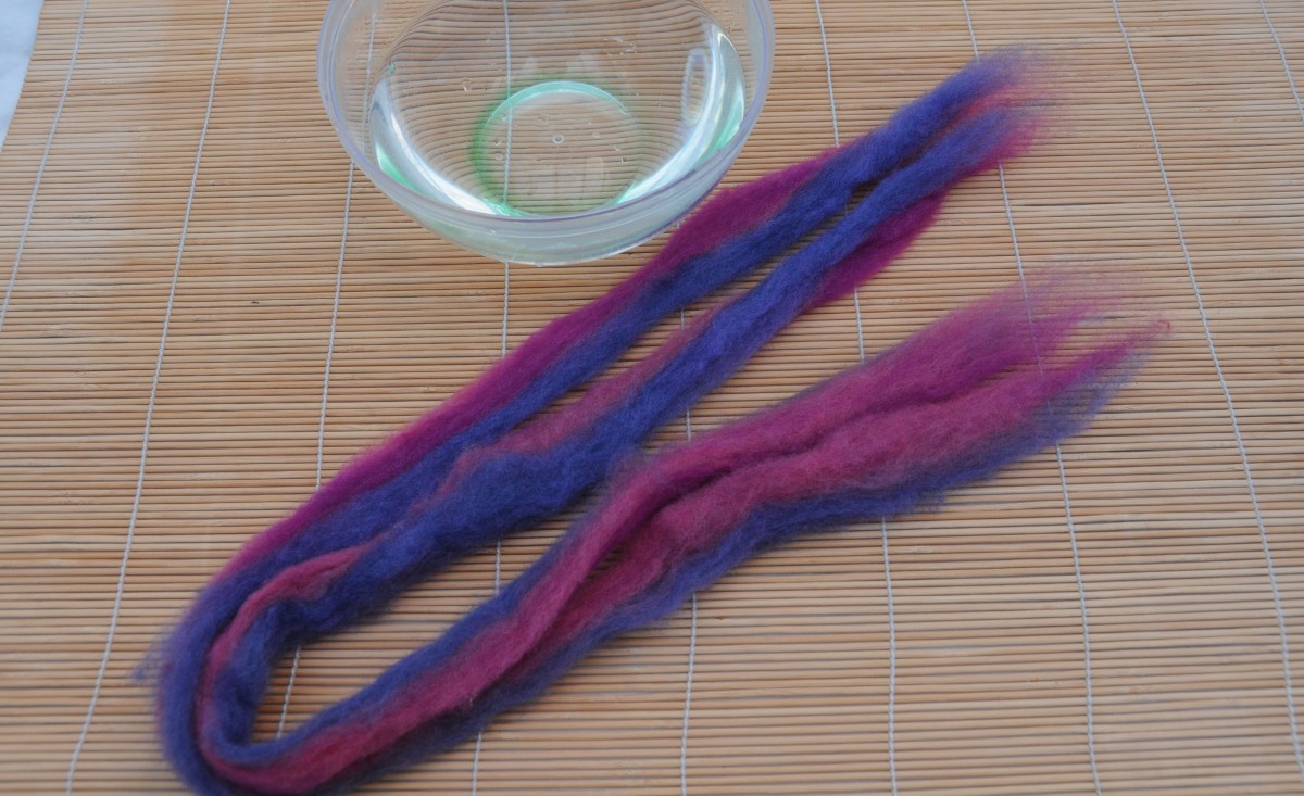 Align the two pieces of pencil roving, wet in hot soapy water and roll.  Two ended dread, folded makes two lengths.