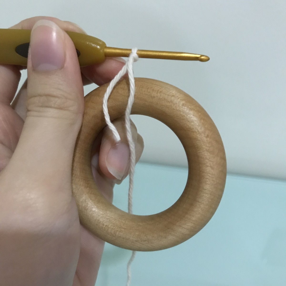 Pull the hook above the ring to start working the stitches.