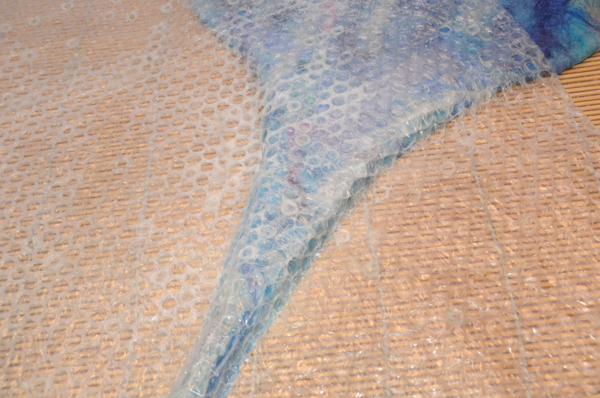 Shaping the curly tail under the bubble wrap.