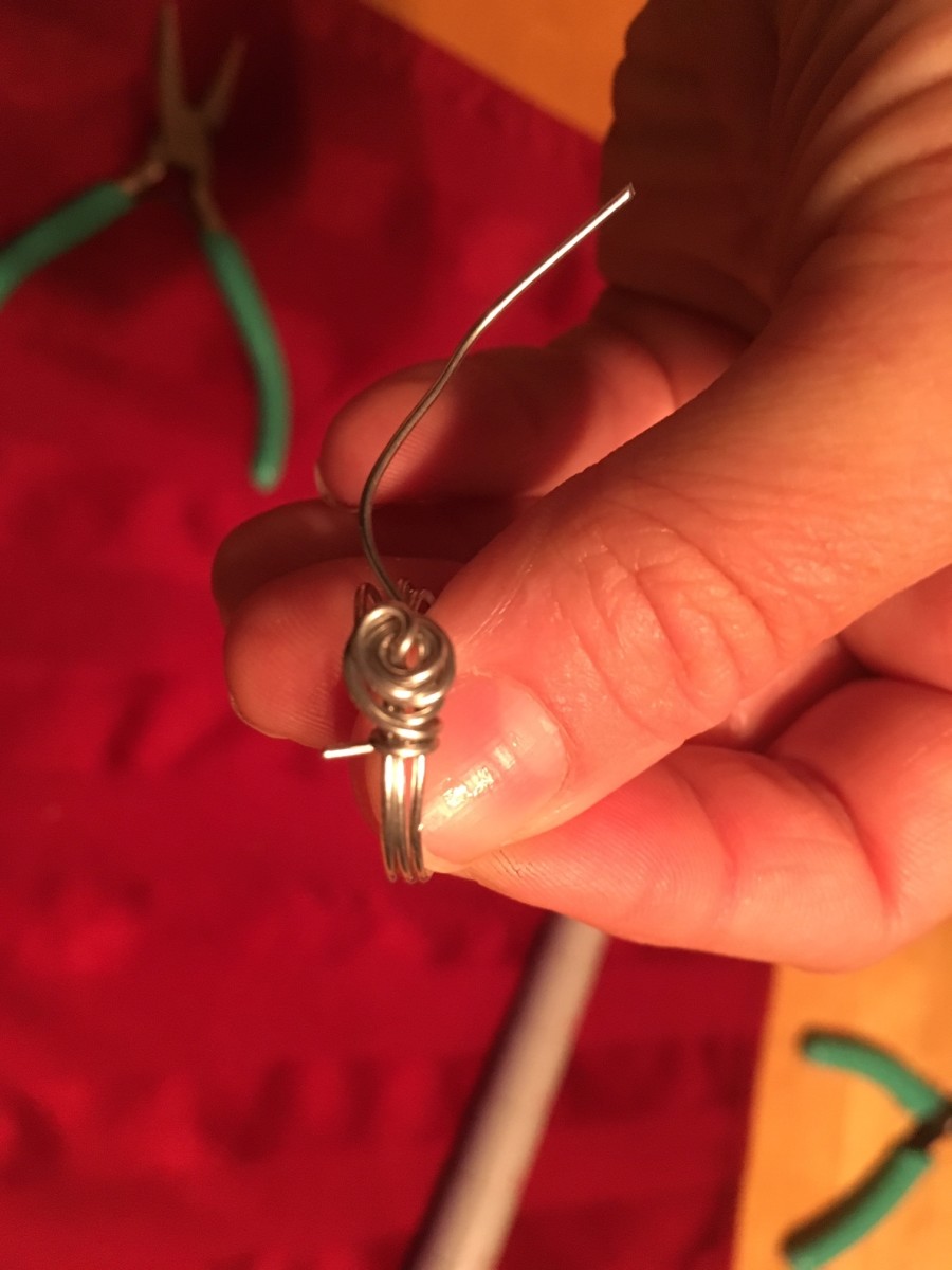 After twisting the wire and forming your rose shape, leave about 1/4 inch remaining on either end. 