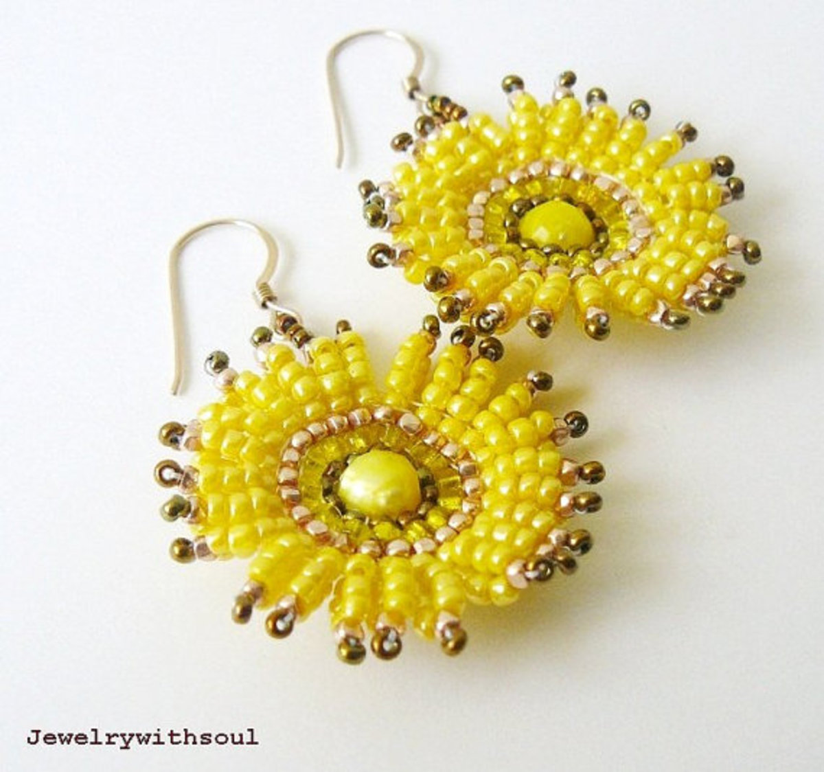 This pair of yellow beaded flower earrings resemble daisies or sunflowers.