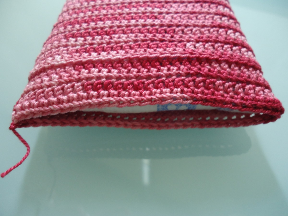 Here is the body of the cozy finished up to Round 26. You can see a line a few rows beneath the top that consists of the freed front loops of Round 23.