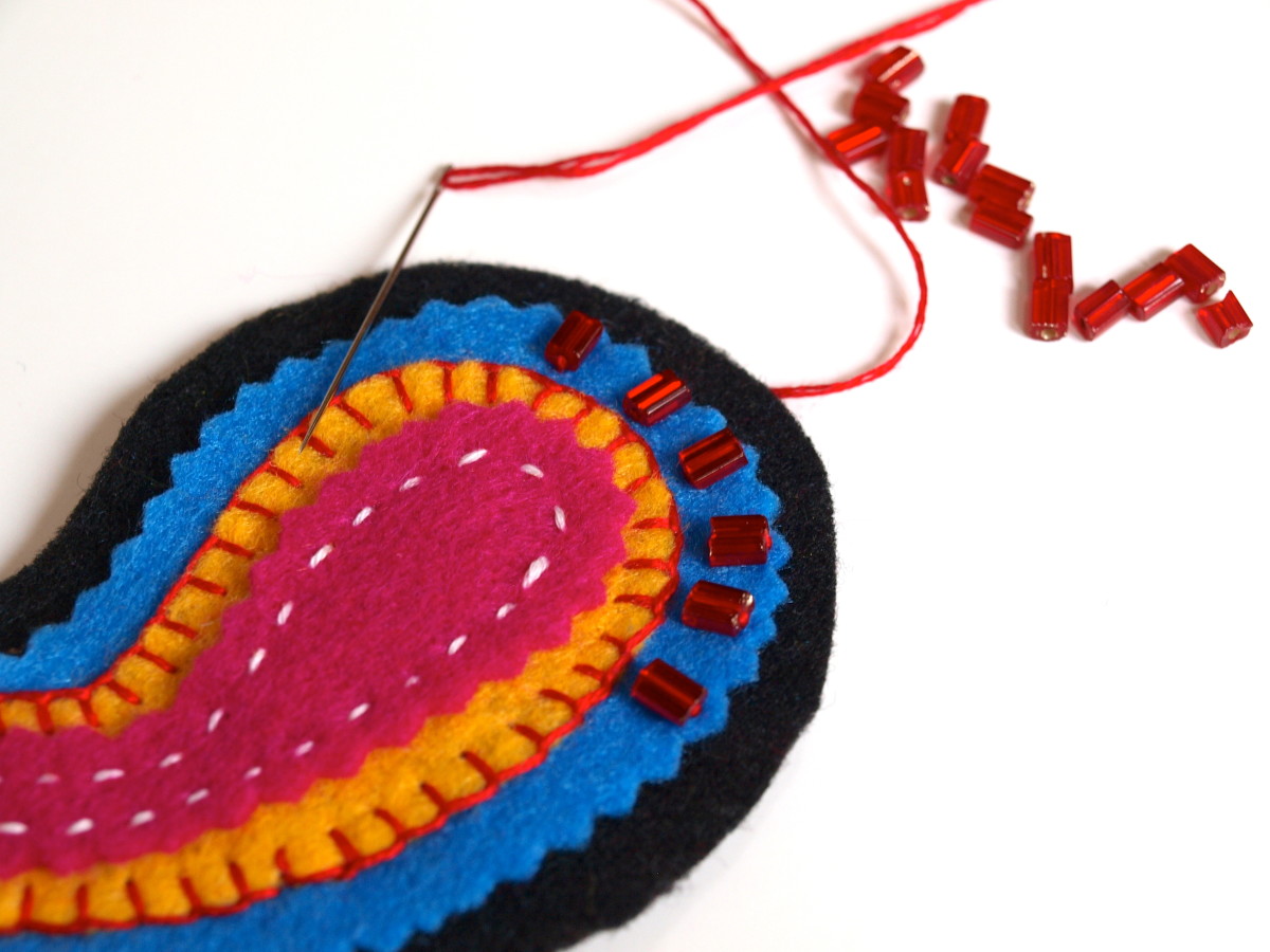 Use beads to sew the top layers to the backing.