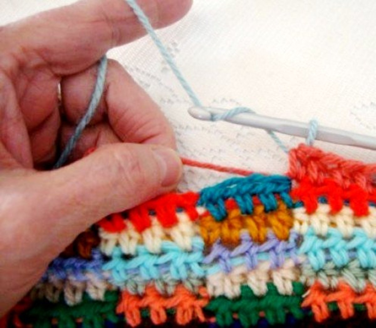 CARRYING COLOR--gently pull on yarn strand (rust) so it doesn't loop or bunch up