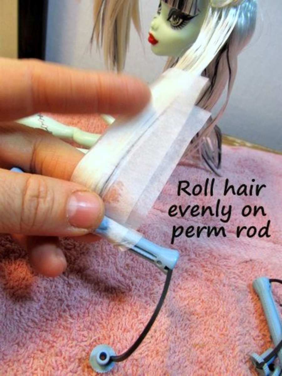 Place the hair in an open perm rod, preparing to roll it up evenly.