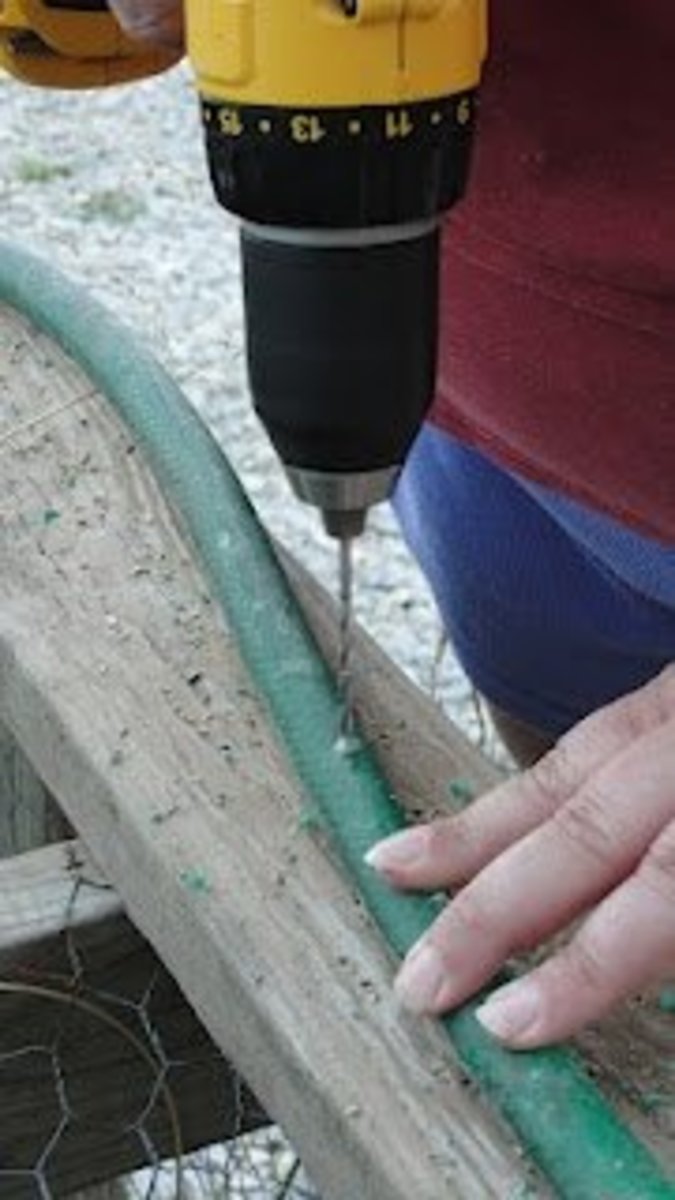 Drilling holes to turn an old hose into a sprinkler or soaker.