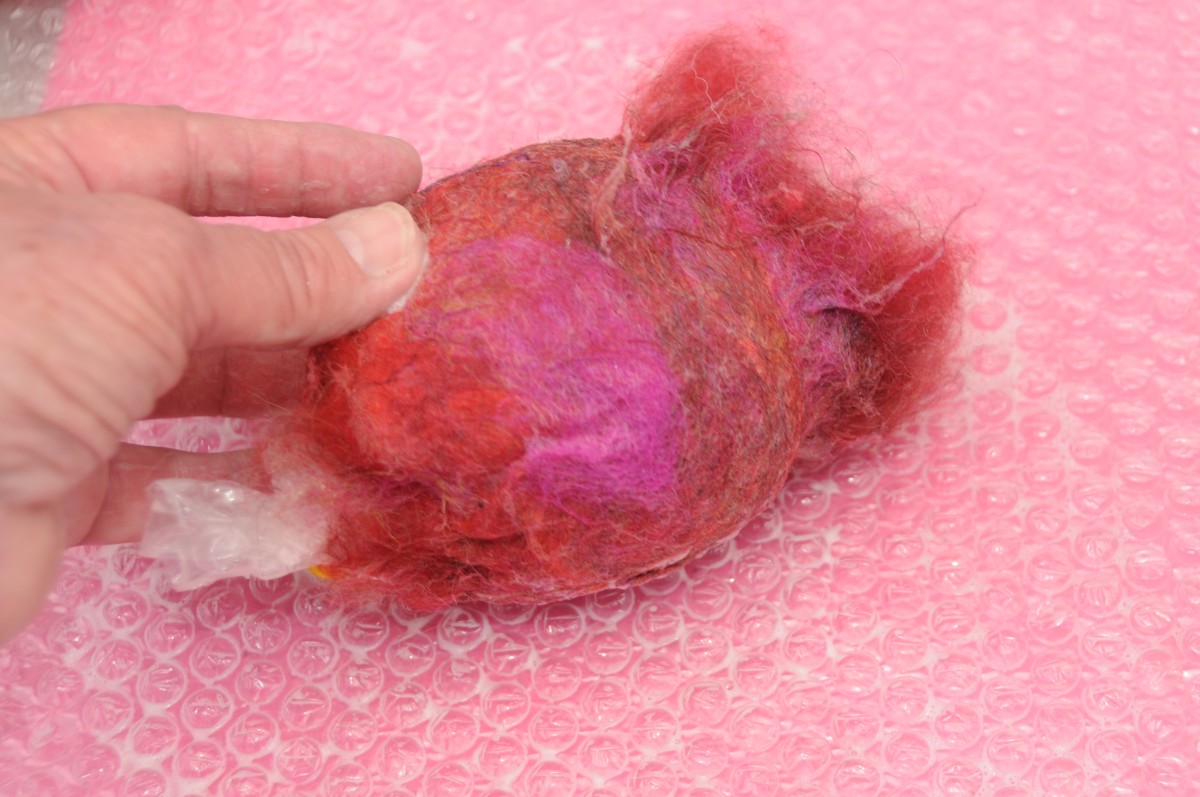Smooth down the fibers by rolling the balloon on a wet bubble-wrap surface.