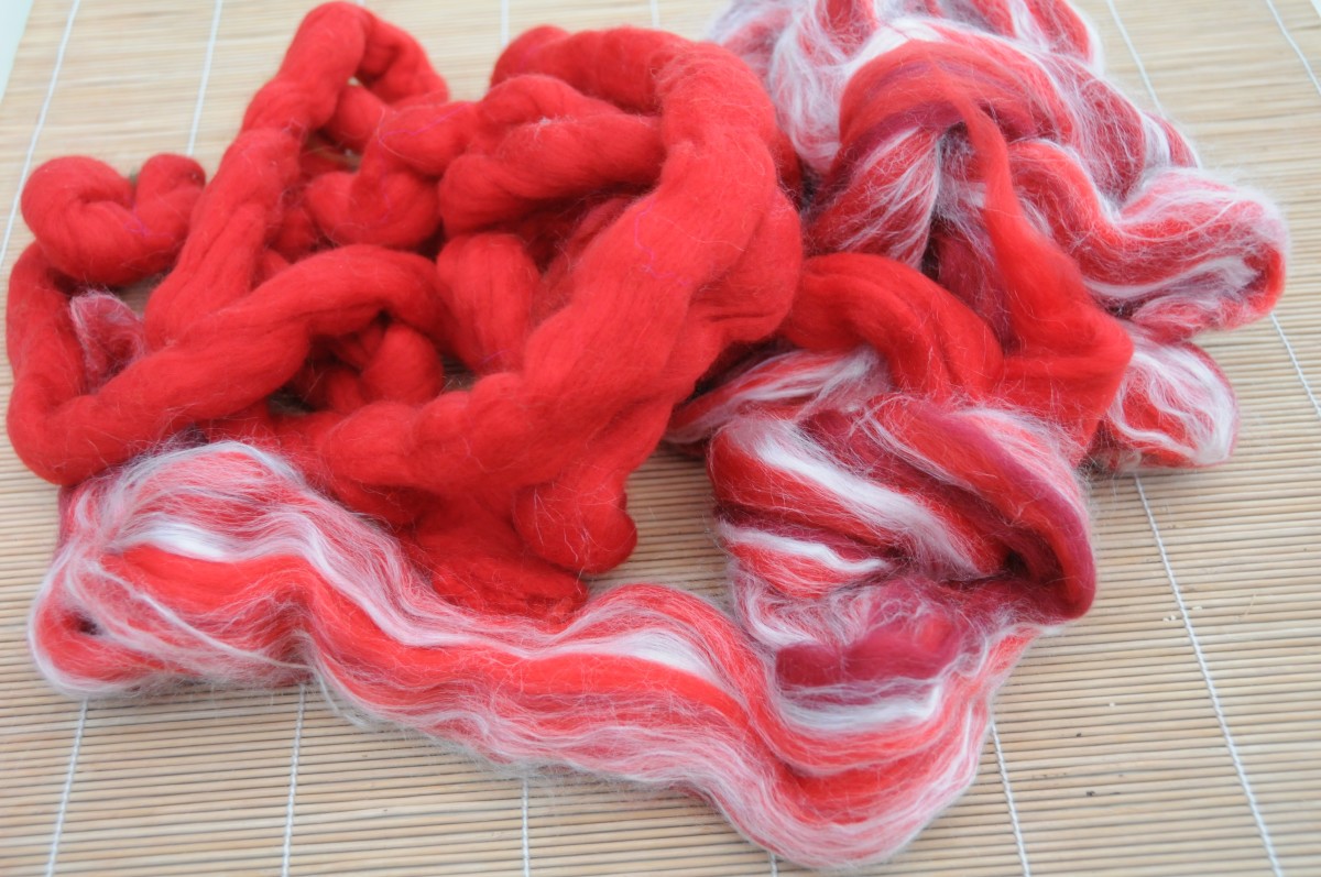 Merino wool roving, some of which has been enhanced with threads of silk