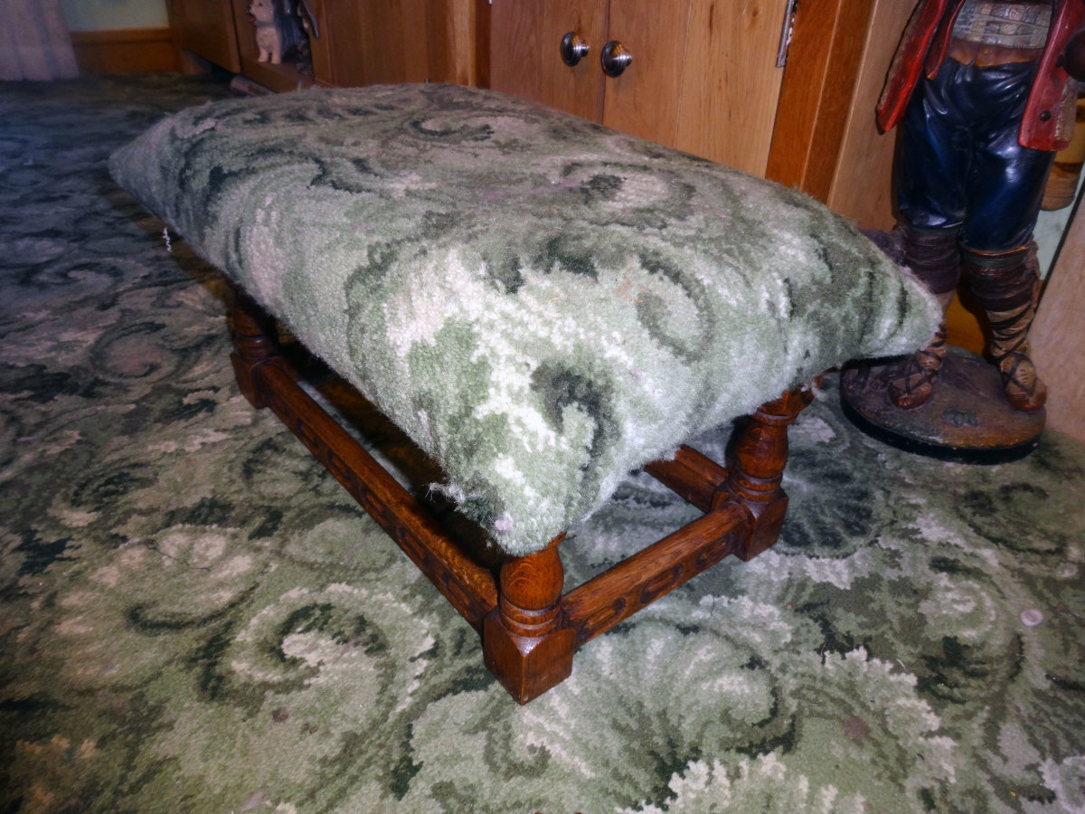 Foot stool upholstered in carpet