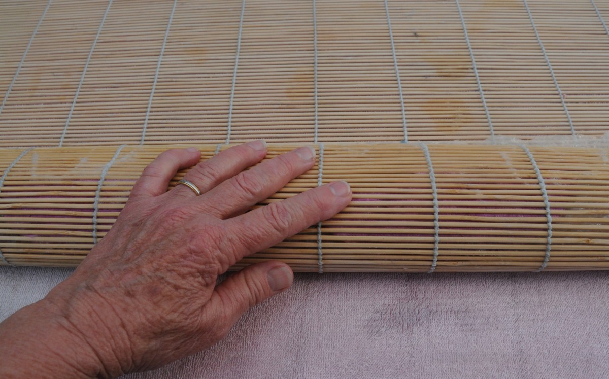 Rolling the slipper inside a bamboo blind