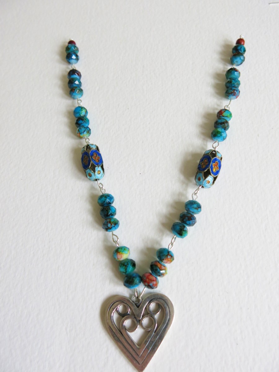 If you want to add more embellishments to your necklace, you can attach hanging beads at each connection point on your beaded chain.