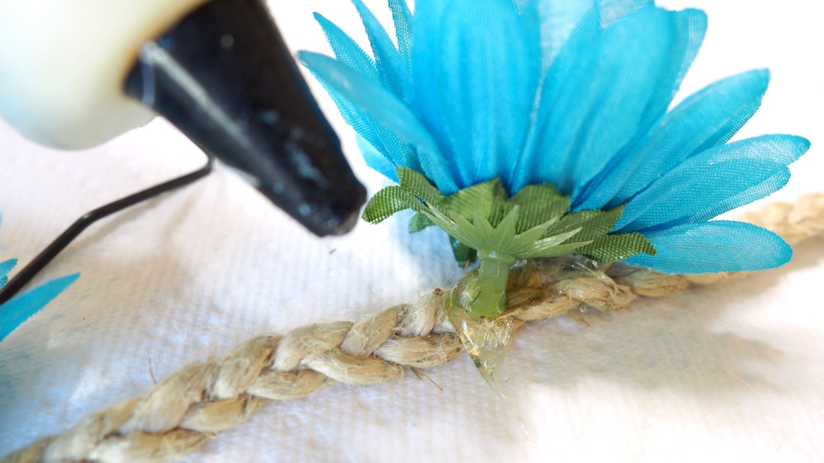 Glueing flowers onto braid.