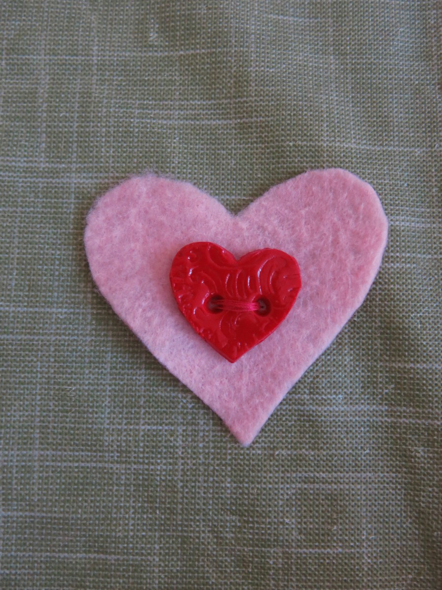 Decorate the hearts however you choose. I sewed a button onto the first heart of my bookmark.