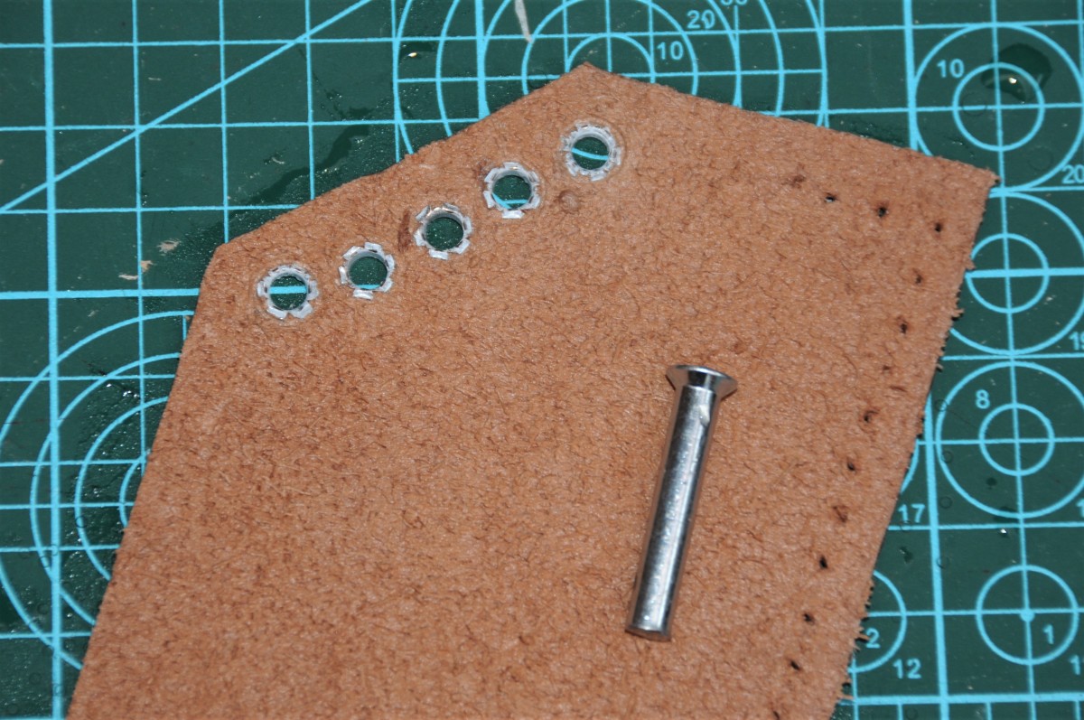 Insert the eyelets or rivets using the small punch usually supplied with the eyelets.
