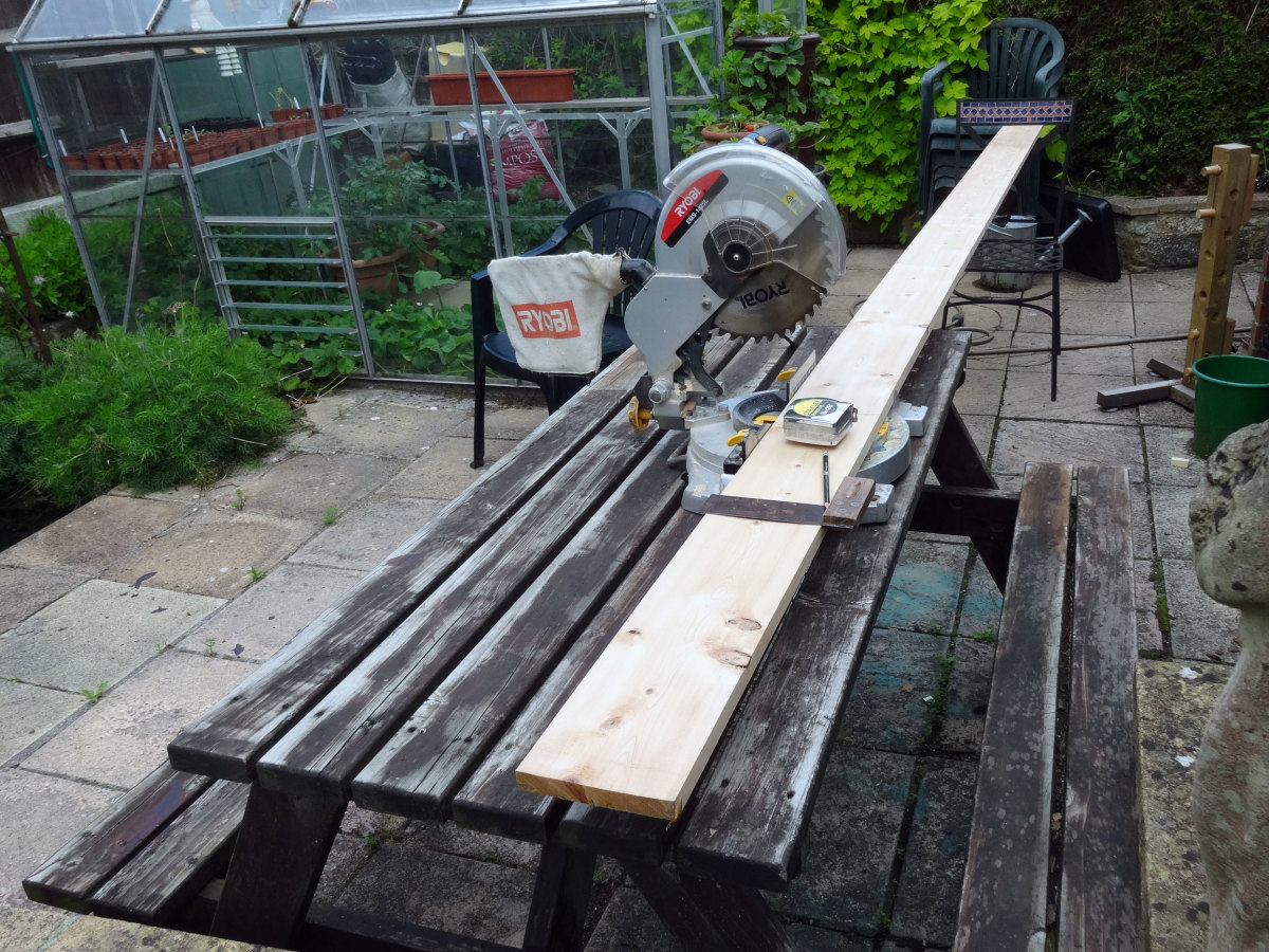 Using tape measure, square and pencil to mark the wood, to cut to correct length with a mitre saw.
