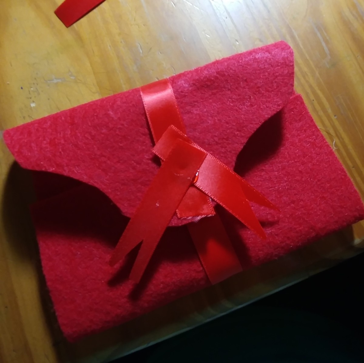 Glue pieces of ribbon on front of envelope.