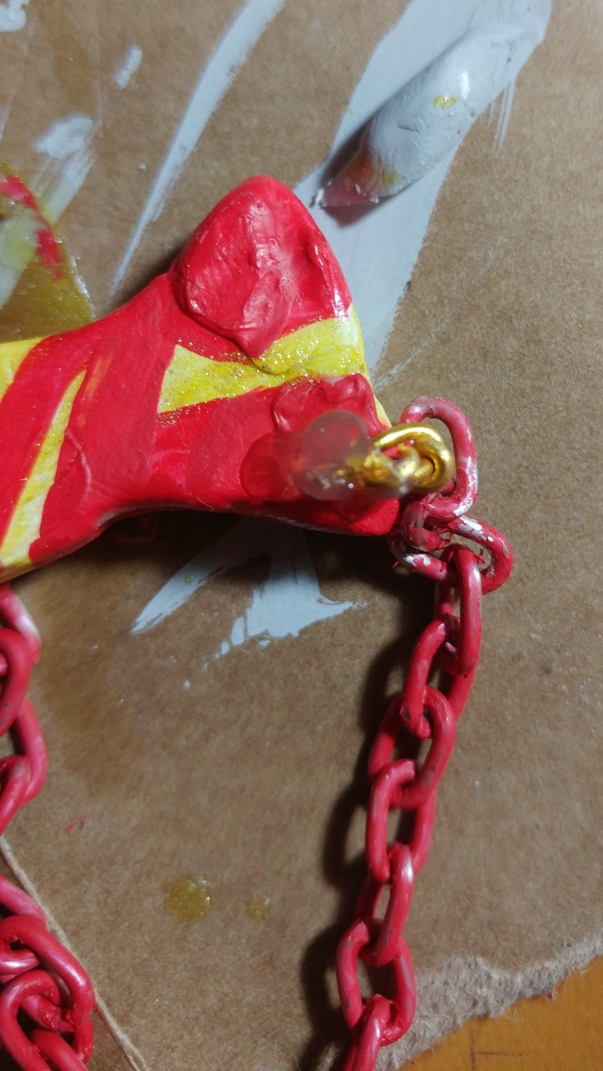 Apply hot glue to the wire on the back of key chain. This also buffers the sharp points of the wire.