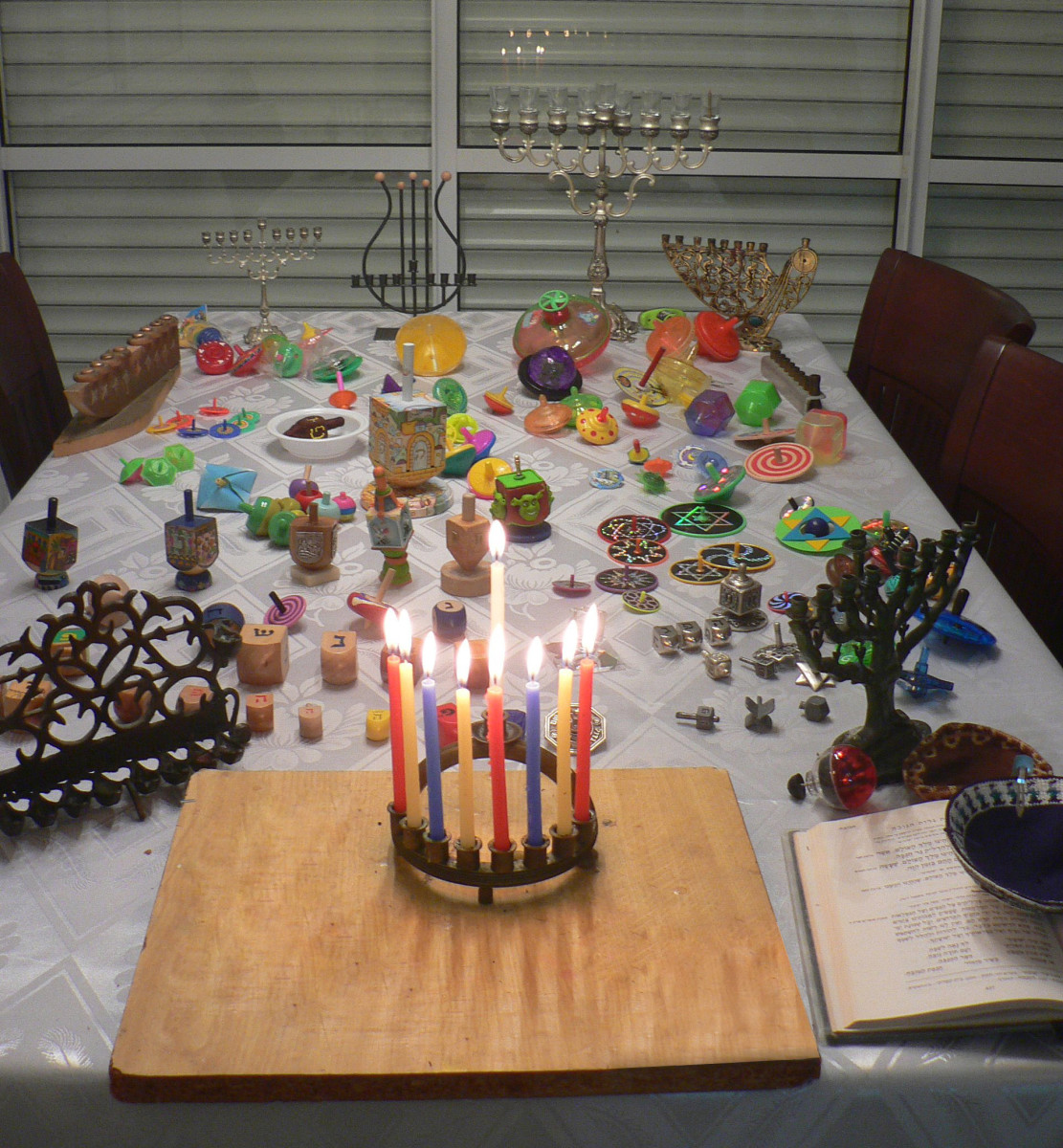 The menorah and dreidel are traditional Hanukkah objects.