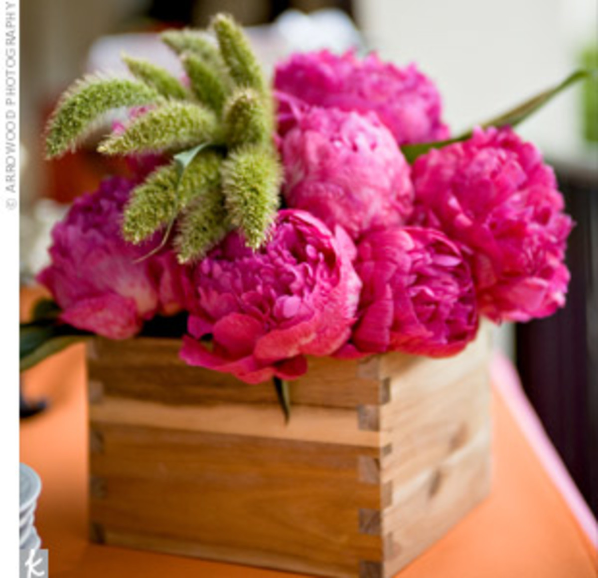 A wooden box provides a unique vessel for this very easy to make peony and millet centerpiece sent in by a real bride to the Knot.