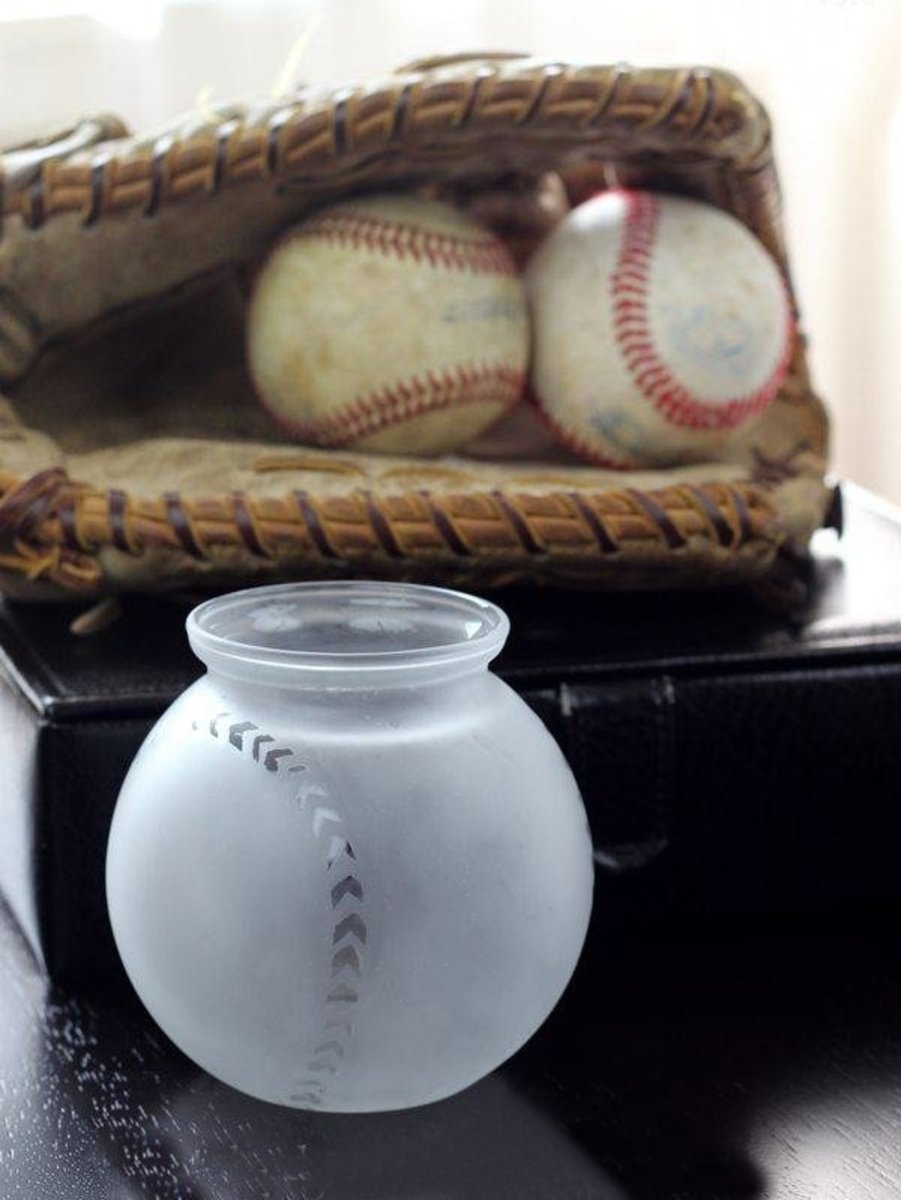 For a sports fan, a homemade baseball-themed storage container can be a nice gift alternative to a baseball hat. 