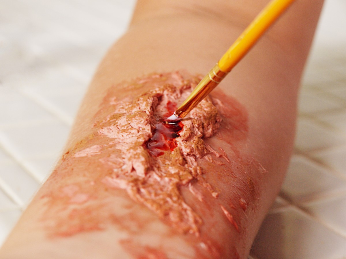 8. Top off with fake blood. Use a paintbrush to apply. Start with a little and add more to create a realistic look.