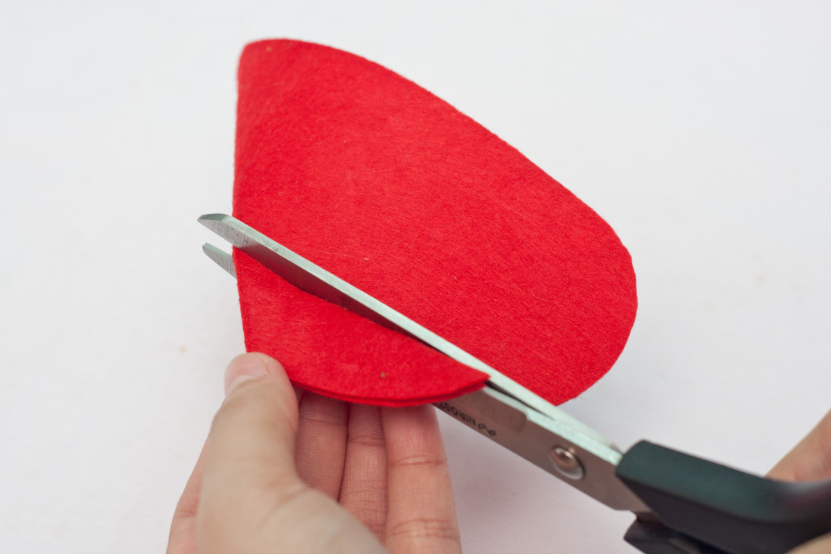 Fold the red felt heart in half and cut a V shape out of the middle top area