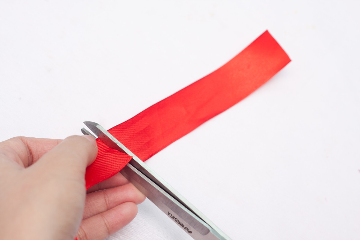 Cut a small piece of red satin ribbon