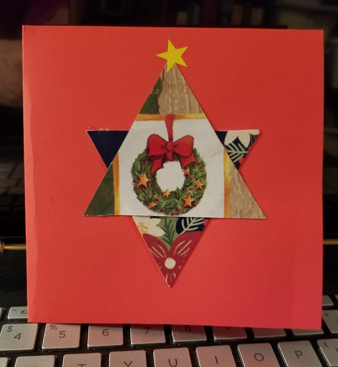 My friend made this simple, yet attractive holiday card. She cut 2 triangles from an old Christmas card and glued them to form a star. Then she added a star sticker at the top. I love it!