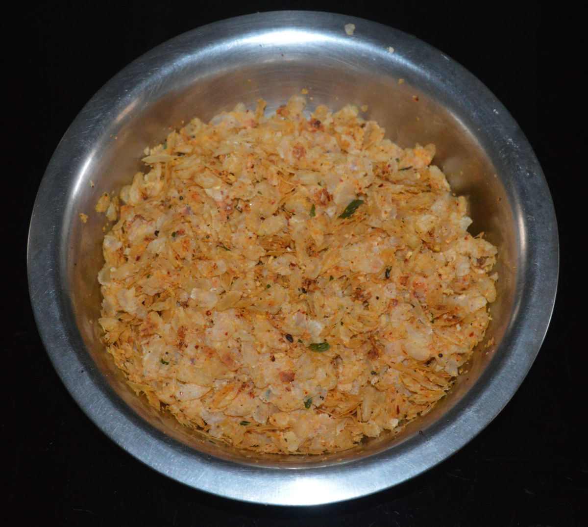 Step four: Gently mix so that the flattened rice gets nicely coated with the masala paste and the tempering. Check for taste and add more salt if needed.