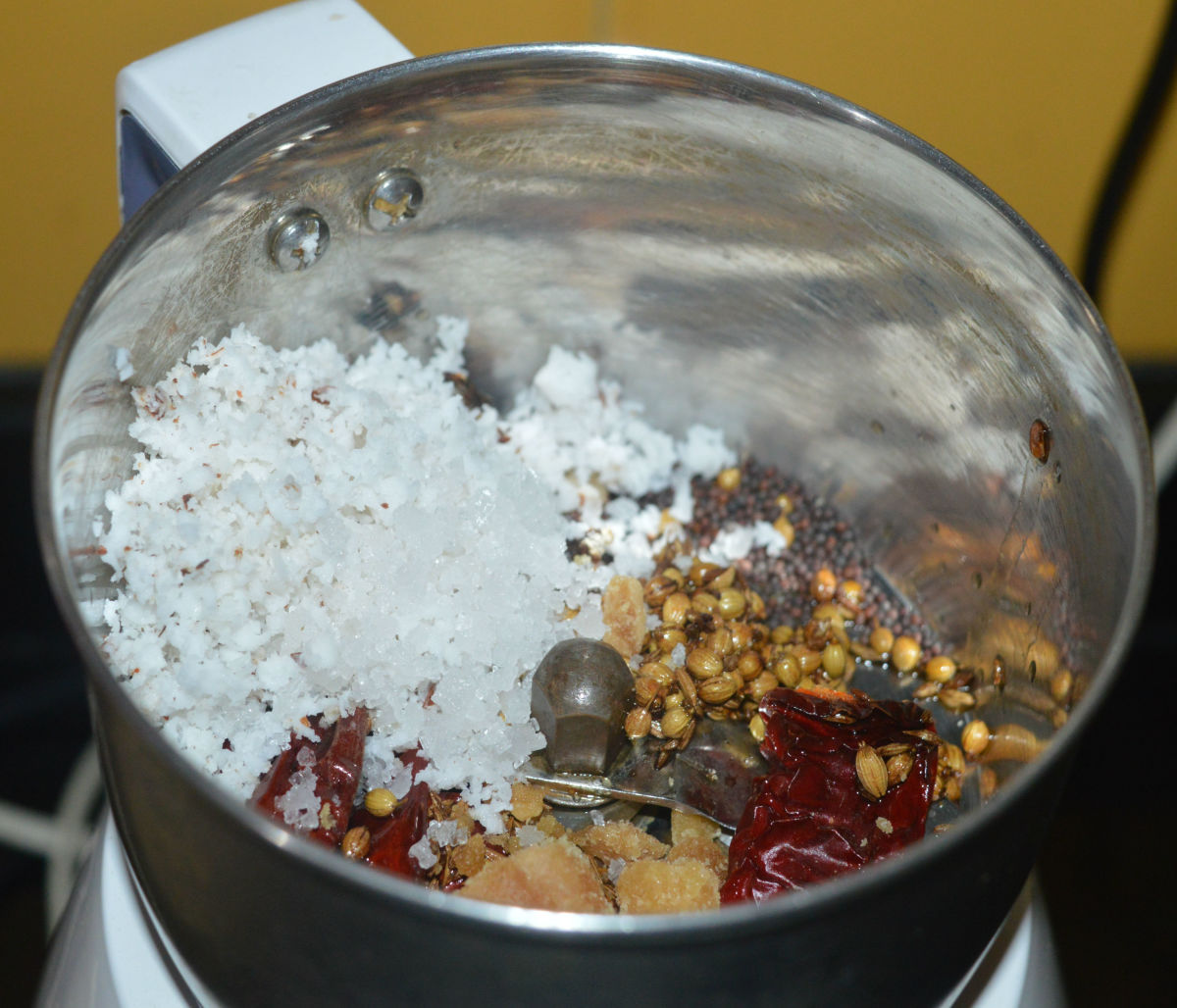 Add half of the grated coconut, jaggery powder, mustard seeds, and salt.