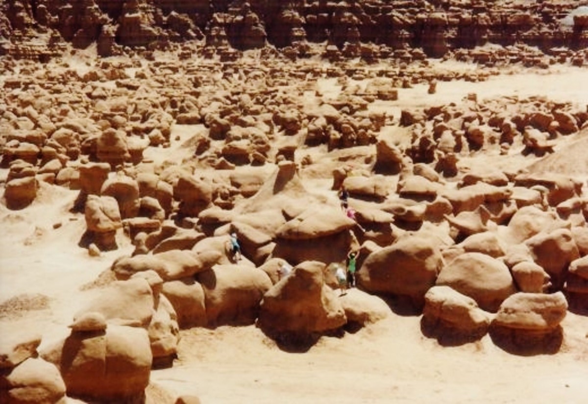 Picture showing all of the people playing among the rock formations in Goblin Valley State Park.  Photo taken from the raised picnic area above.