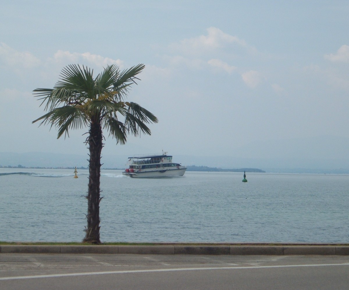 A boat leaves Peschiera to travel the lake.