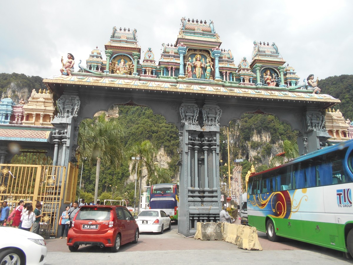 Cars and tourist buses entering the carpark to visit the Batu Caves.