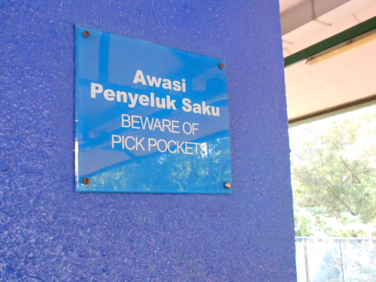 In crowded areas and train stations, public announcements and signs like this helps to remind the people to be mindful of their personal belongings.