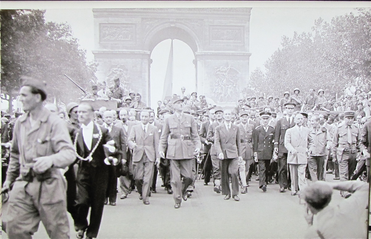 Charles de Gaulle marching under the Arc de Triomphe and down the Champs-Elysees following the liberation of Paris in WWII.