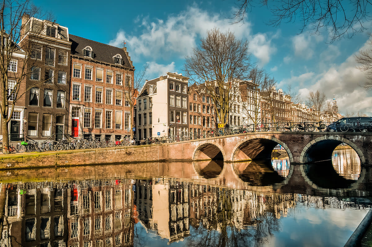 Canal, bridge, narrow houses - typical Amsterdam scene.