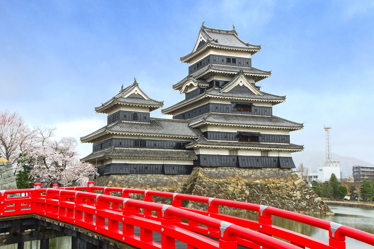 Graceful Matsumoto Castle. Exceptionally lovely when photographed with its vermilion red moat bridge.
