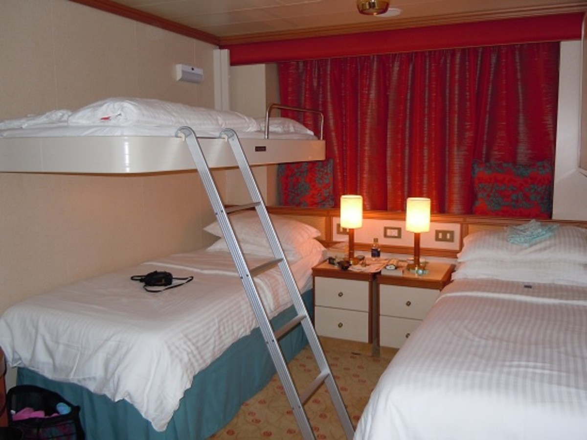 One bunk in position, beds turned down, curtains drawn, bedside lights on to welcome you back after dinner.