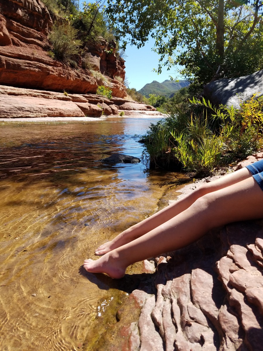 Dipping our feet in the cool waters of Oak Creek at Slide Rock, Arizona.