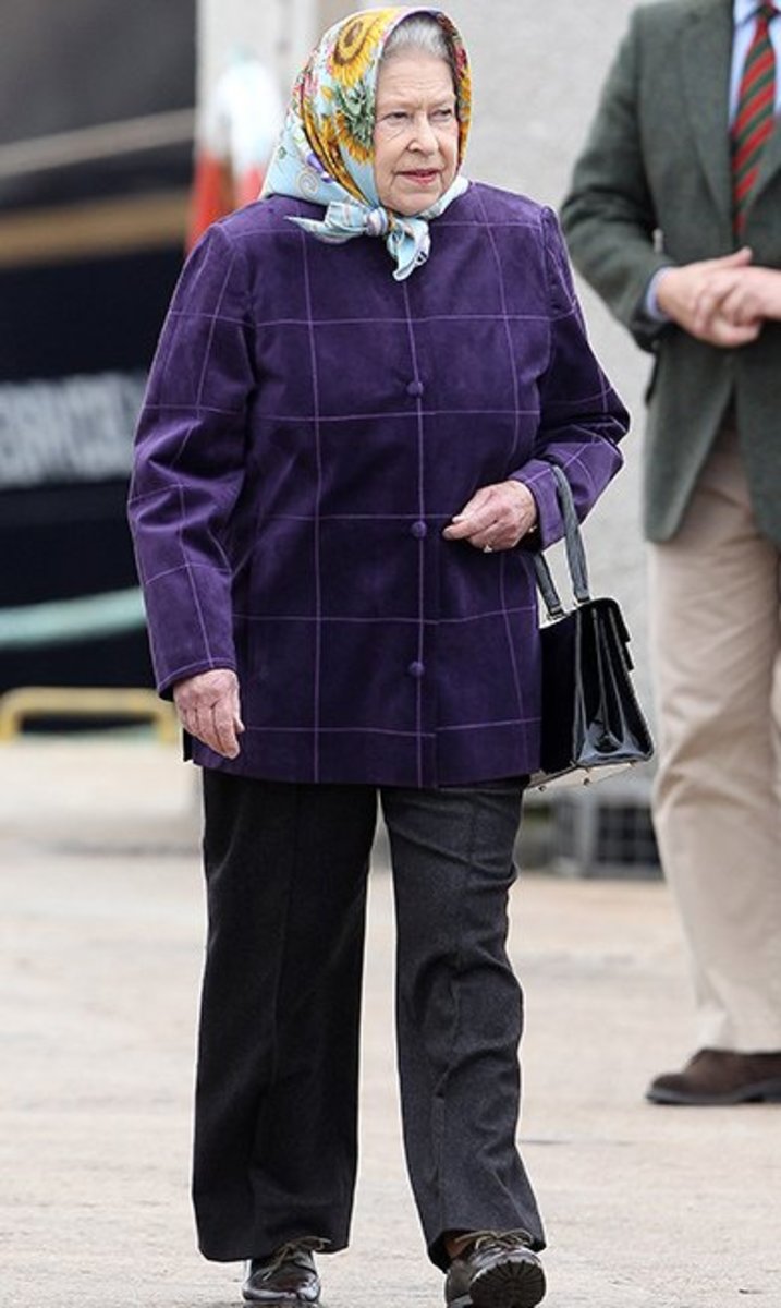 The Queen (in a rare picture wearing pants) owned over 200 Launer handbags.