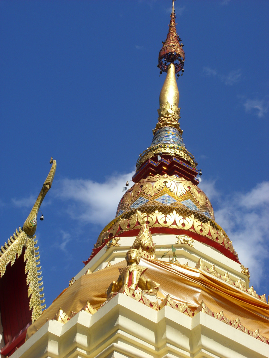 Chedi of Mang Meung Temple in Chiang Mai showing the intricate artistic detail typical of many chedi in Thailand