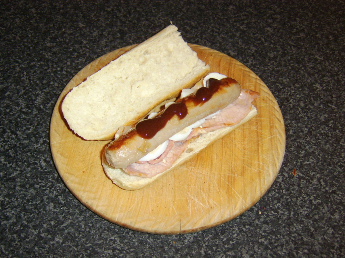 A hearty sausage, bacon and egg sandwich with optional HP Sauce - the perfect early morning munch when sea fishing