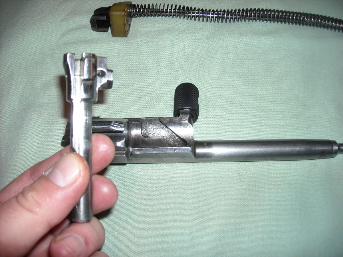 Take the bolt and place the small end into the opening on the bolt carrier.