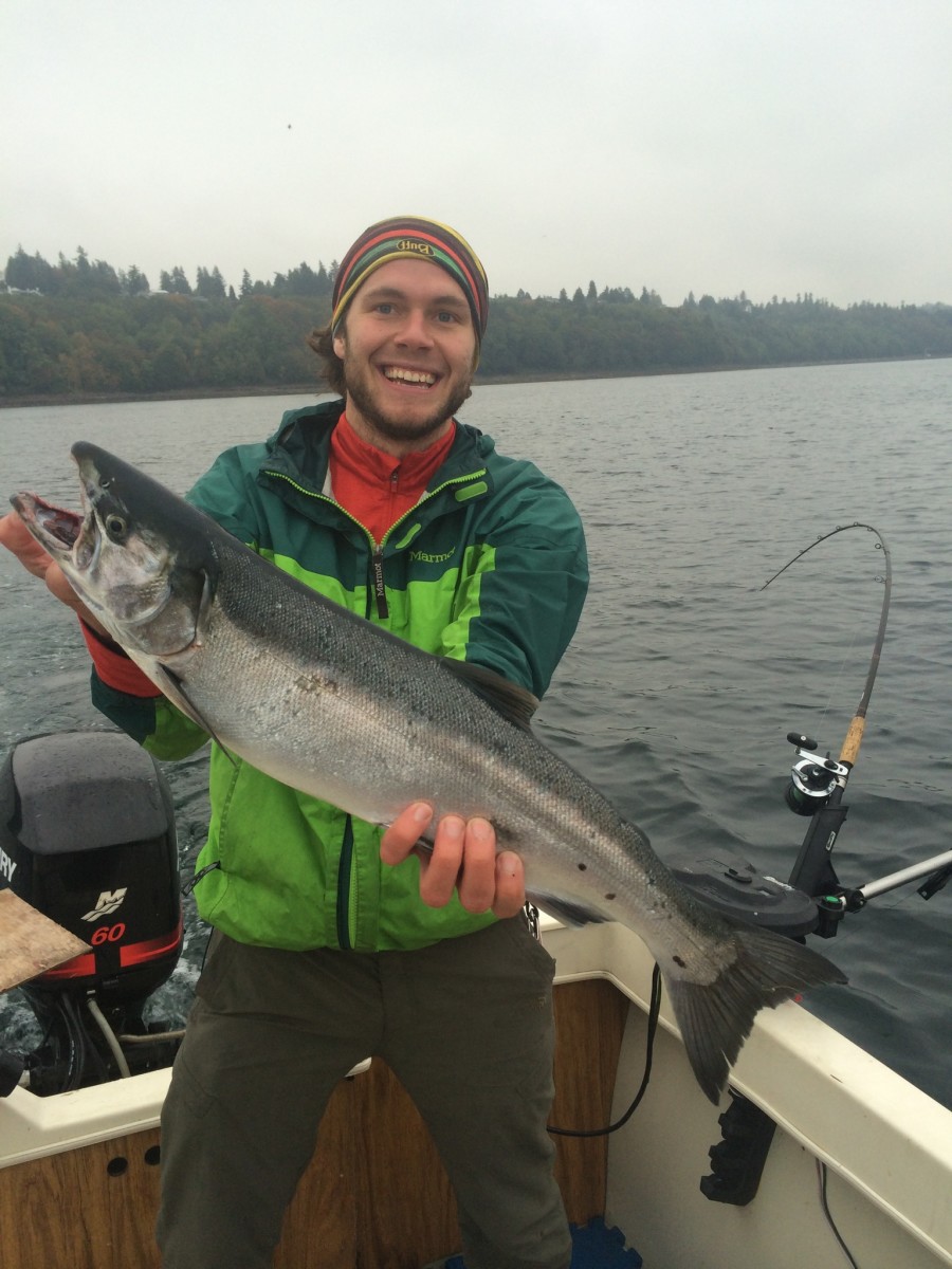 Myself, unapologetically holding a 5lb Coho (also known as Silver) as close to the camera as possible. Caught while trolling.