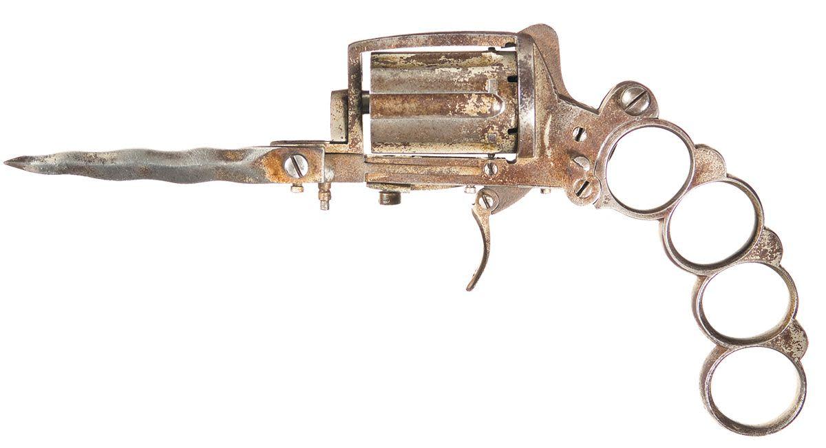 The pistol, with the knuckle duster and dagger extended.