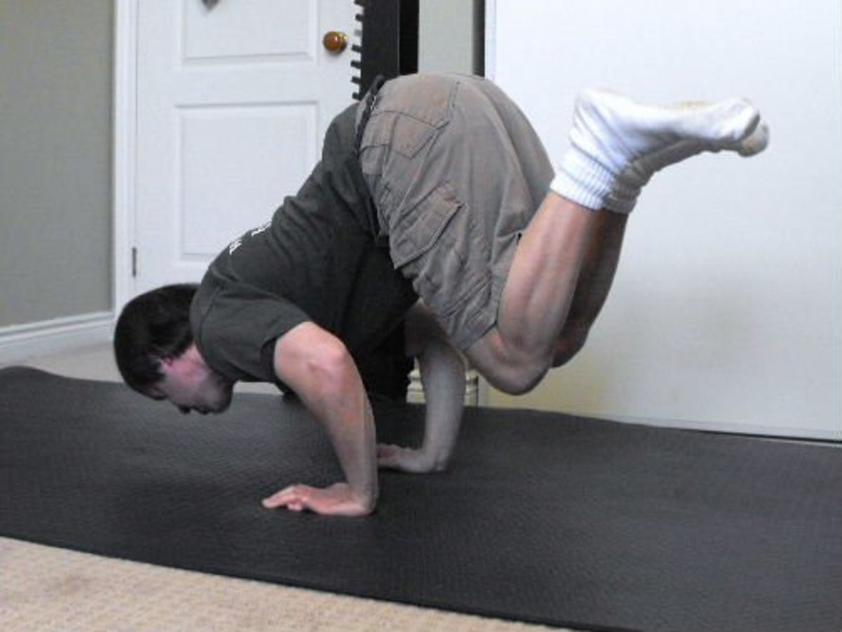 Me doing a tucked push-up with legs in the air.